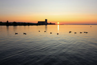 Scenic view of lake against sky during sunset