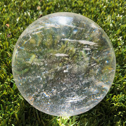 Close-up of glass ball on grass