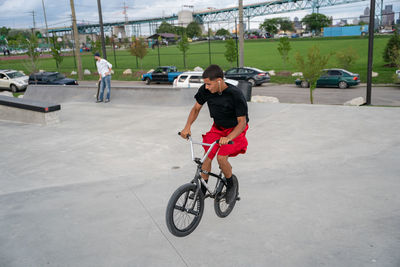 Man riding bicycle on street in city