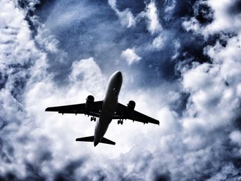 Low angle view of airplane flying in sky