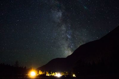 Silhouette mountain against star field