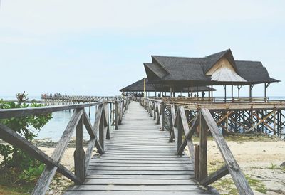 Long wooden jetty leading to calm sea