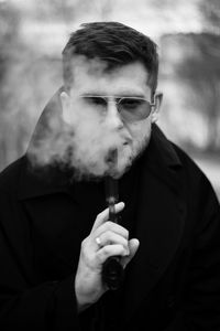 Young man smoking electronic cigarette