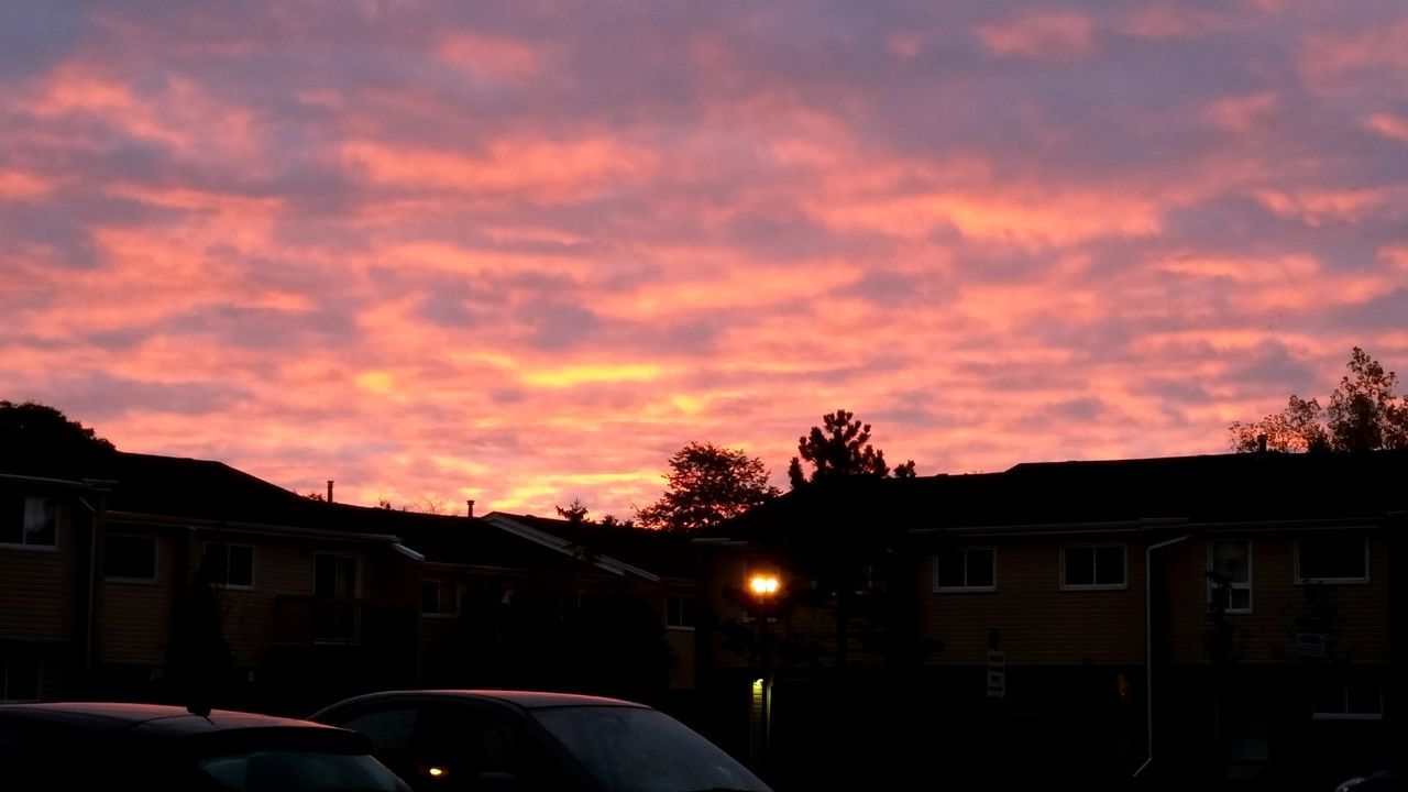 SILHOUETTE HOUSES AGAINST SKY DURING SUNSET