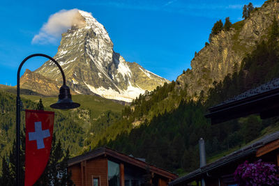 Scenic view of mountains against blue sky