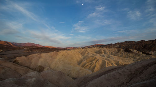 View of desert against cloudy sky