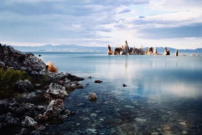 Scenic view of rocks in sea against sky
