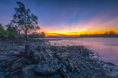 Scenic view of rocks against sky during sunset