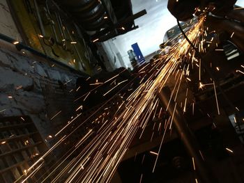 Low angle view of illuminated industry at night