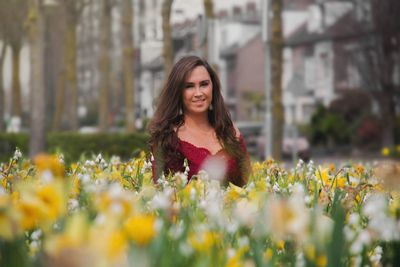 Portrait of smiling woman with yellow flower