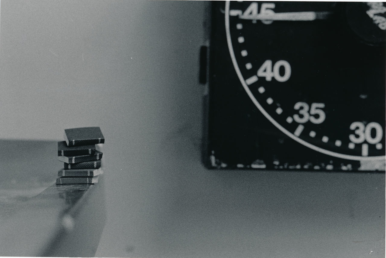 CLOSE-UP OF TELEPHONE BOOTH ON TABLE