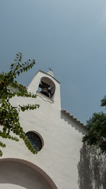 Low angle view of bell tower against sky