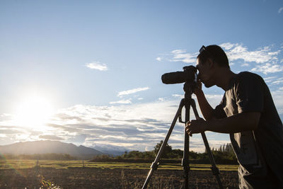 Silhouette young men travelers standing are shooting photograph