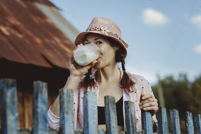 Happy mature woman drinking glass full of fresh milk