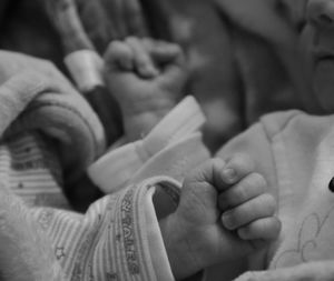 Midsection of baby hands