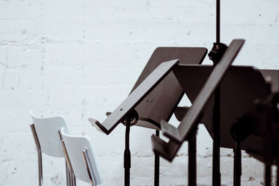 Chairs and music stands against wall