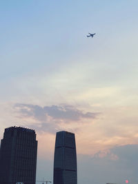 Low angle view of buildings against sky during sunset