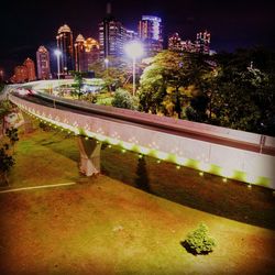 Illuminated city against sky at night