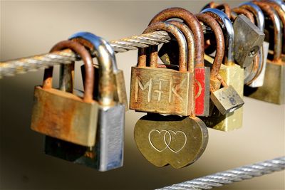 Close-up of padlocks hanging on steel cable