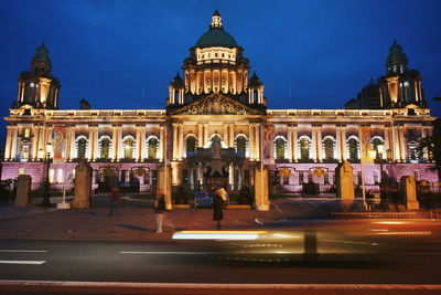 Illuminated belfast city hall against blue sky at night