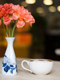 Close-up of white roses in vase on table