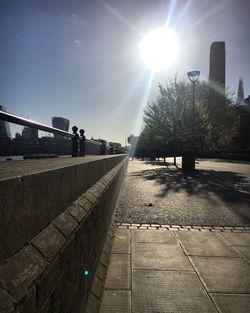 Street amidst trees against clear sky