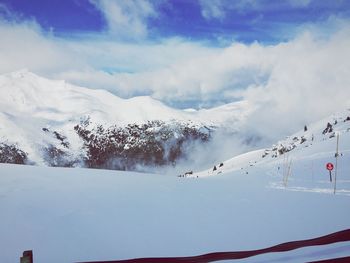 Scenic view of snowcapped mountains against sky