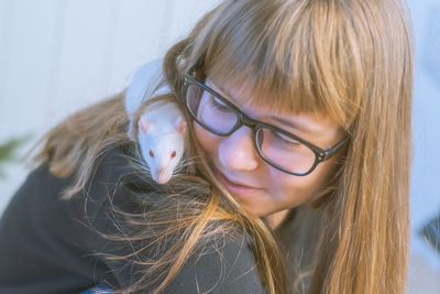 Close-up of smiling girl with rat