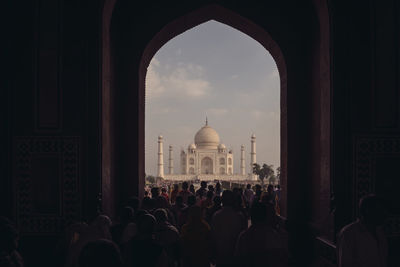 People in front of taj mahal against sky