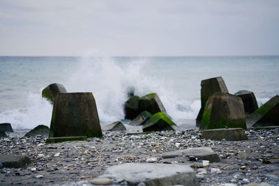 Panoramic shot of rocks on sea against sky