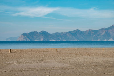 Scenic view of sea and mountains against sky