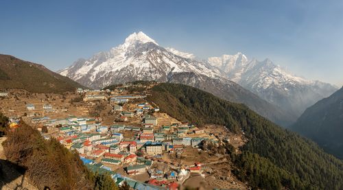 High angle view of townscape and mountains against sky