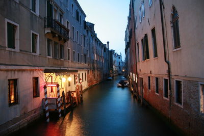 Boats in canal with buildings in background
