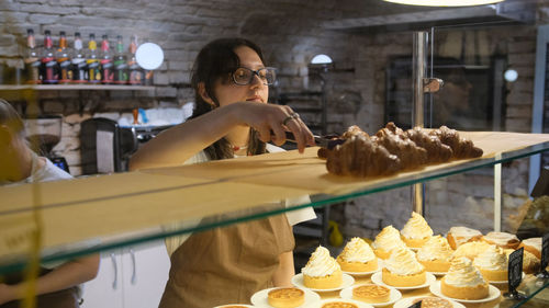 Portrait of woman holding food in restaurant