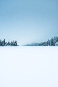 Scenic view of snow covered land against sky