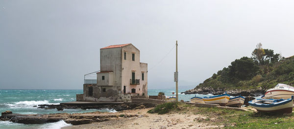 Building on beach against clear sky