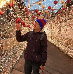 Man holding illuminated decoration