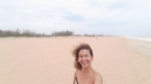 Portrait of smiling woman at beach