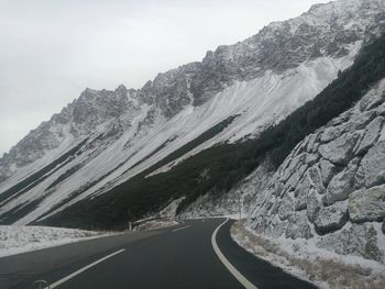 Road amidst mountains against sky