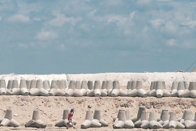 Full frame shot of white stones on beach against sky