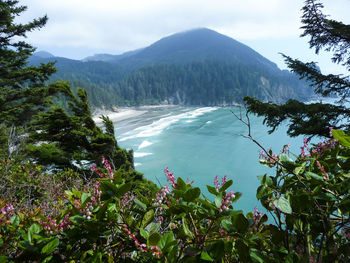 Scenic view of sea and mountains against sky