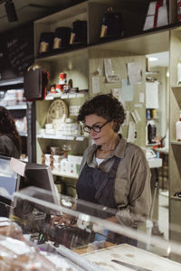 Female owner working in deli store