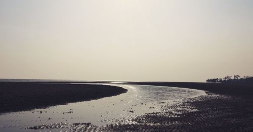 Scenic view of sea against clear sky during sunset