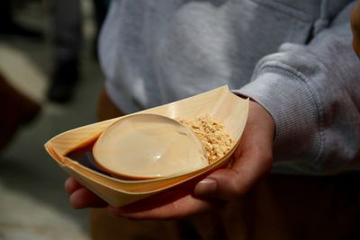 Cropped image of man holding food