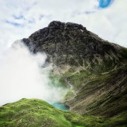 Scenic view of volcanic mountain against sky