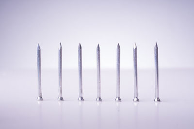 Close-up of metallic objects over white background