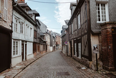 Narrow street amidst buildings in city