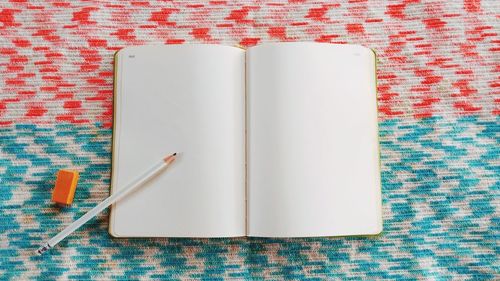 Directly above shot of pencil and book on table