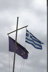 Low angle view of flags against sky