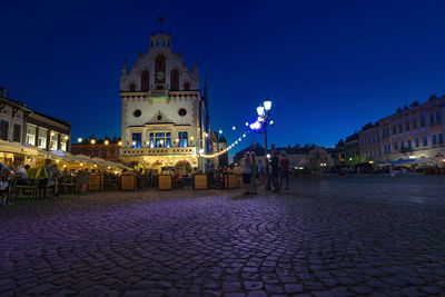 Illuminated buildings in city at waterfront